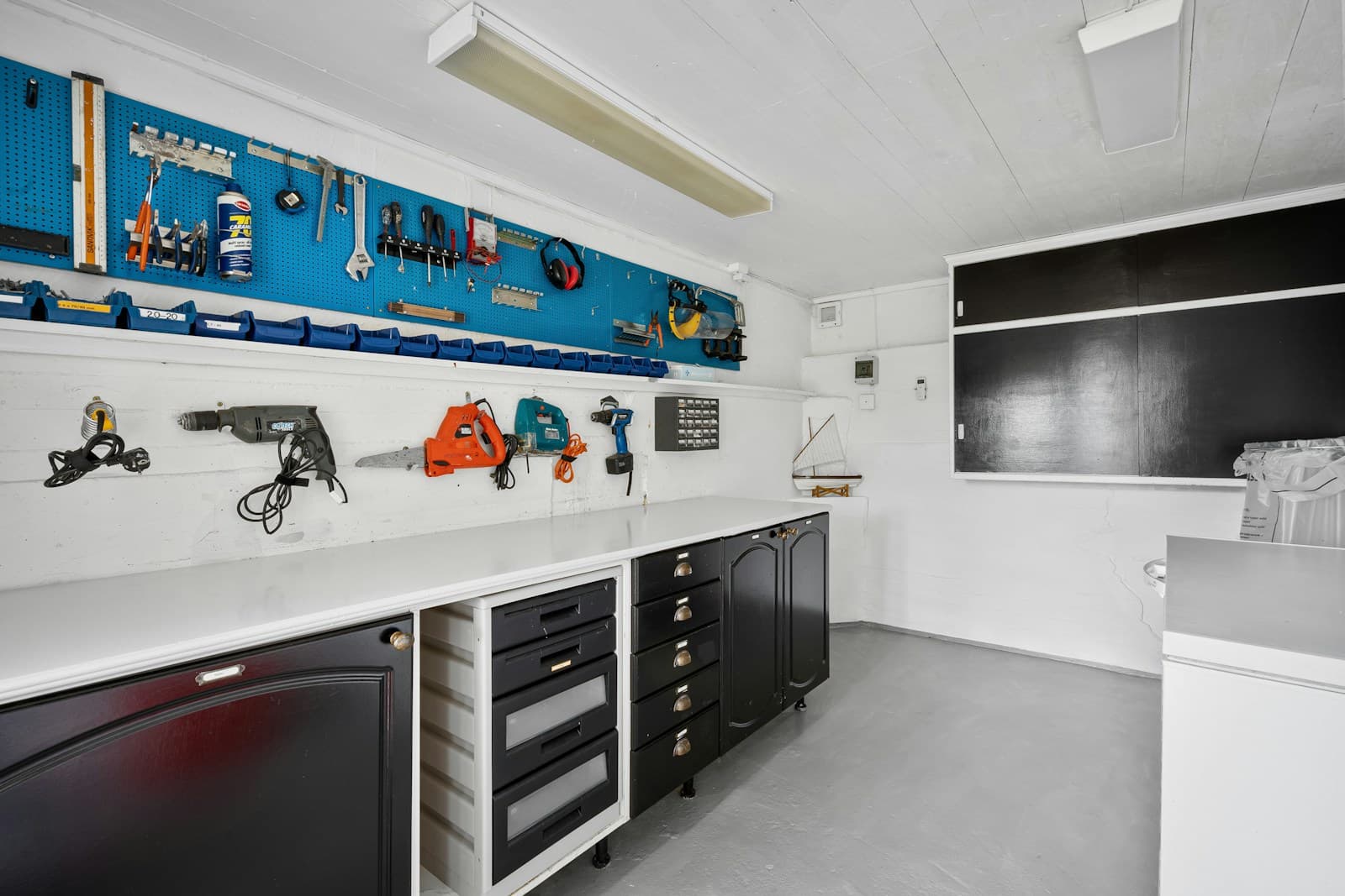 Garage workbench with organized cabinets and drawers